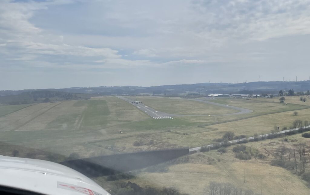 View during landing approach on airfield Siegerland, requested to us to land on the gras strip on the left to leave some space for a big bird on the main runway, Airbus ATLAS A400M Transporter